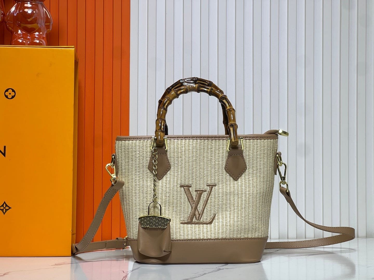 e55d65a2c4d3916bc1575ffe4c2a7993.jpg Louis Vuitton Raffia Petit Bucket Tote - Image 1